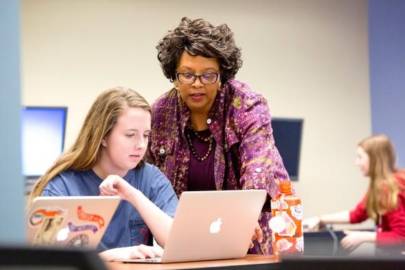 Barbara McCaskill helps English major Laura Essex with a project during her literary magazine editing class. Photo by Dorothy Kozlowski
